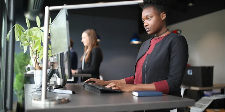 A team of professionals working in a modern office, surrounded by clean and organised IT hardware.